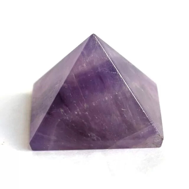 Purple Amethyst crystal pyramid on a white background