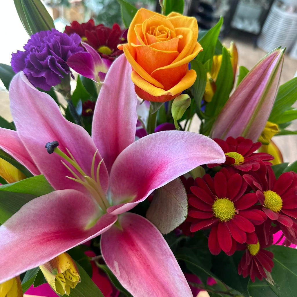 Vibrant mixed seasonal flower arrangement beautifully presented in a regal box.
