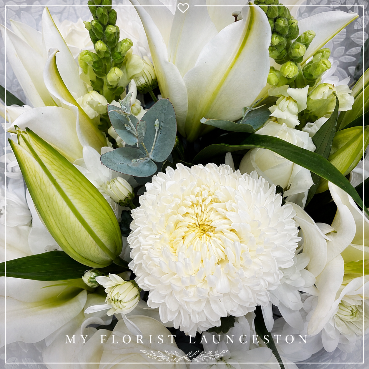 Bunch of white flowers suitable for sympathy gifting.