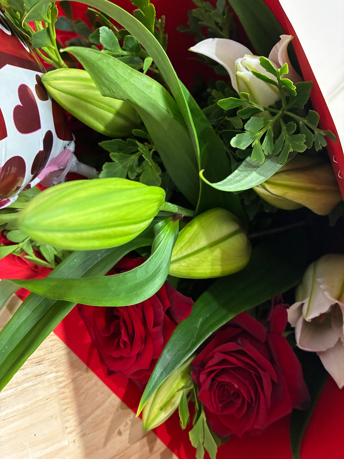 A close-up of a flower bouquet, featuring white lilies, deep red roses, by My Florist in  Launceston Tasmania, offering premium local floral design.