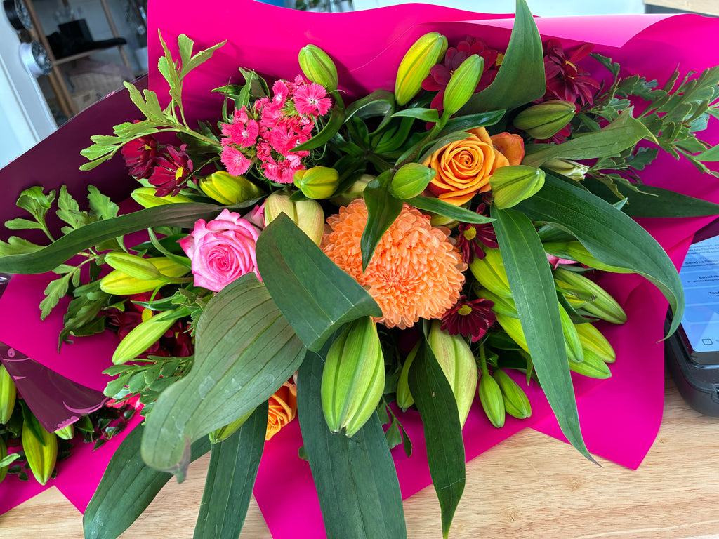 A vibrant floral bouquet featuring pink and orange flowers with Tasmanian foliage by your best florist in Launceston, My Florist