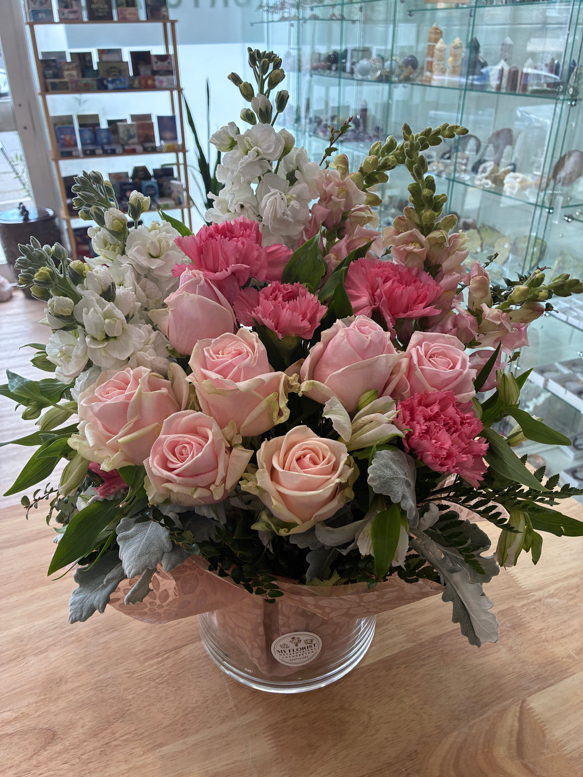 Pretty pastels floral arrangement featuring pink roses, carnations, snaps and stocks in a clear glass vase. Flowers Delivery to Kings Meadows