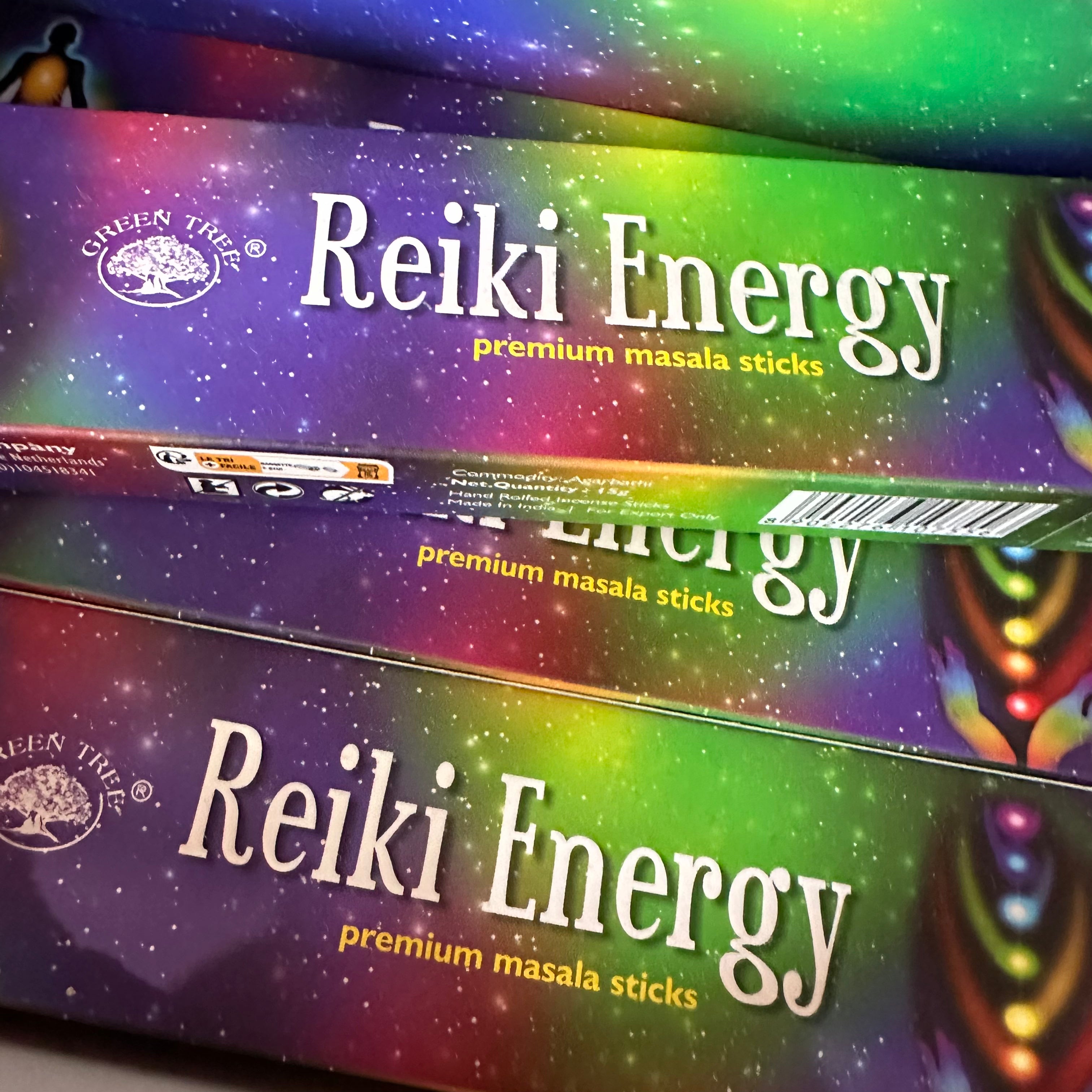 Three boxes of Reiki Energy premium masala sticks with colorful packaging.