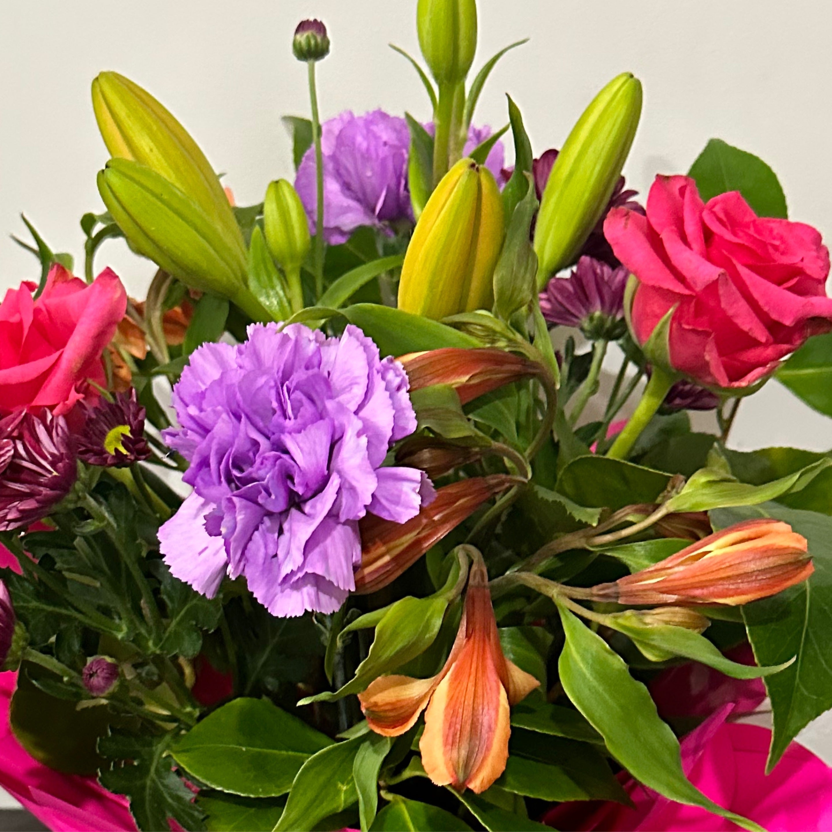 Seasonal flower arrangement including roses