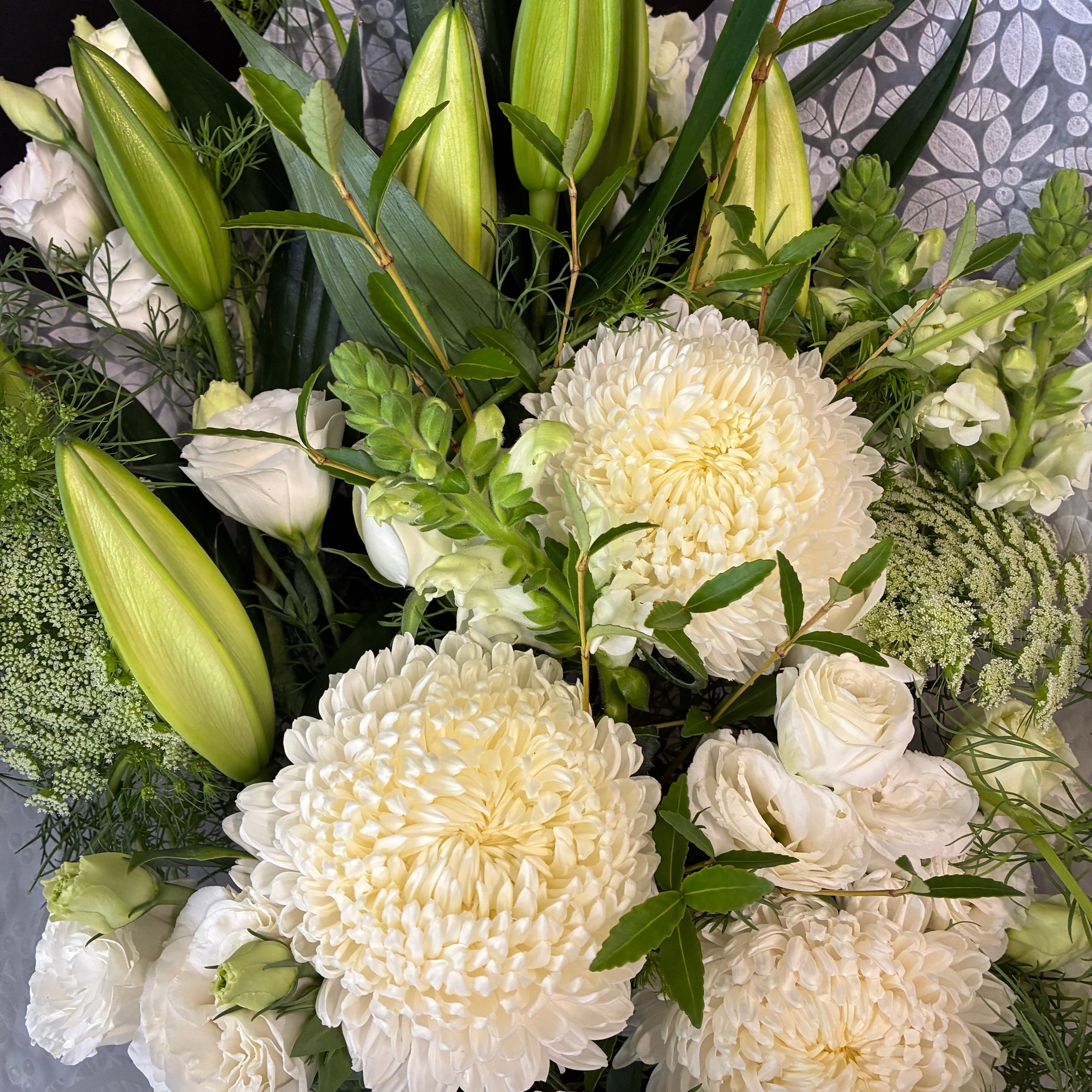 Flat-lying sympathy flower sheaf arrangement custom-crafted for funeral tributes in Launceston Tasmania.