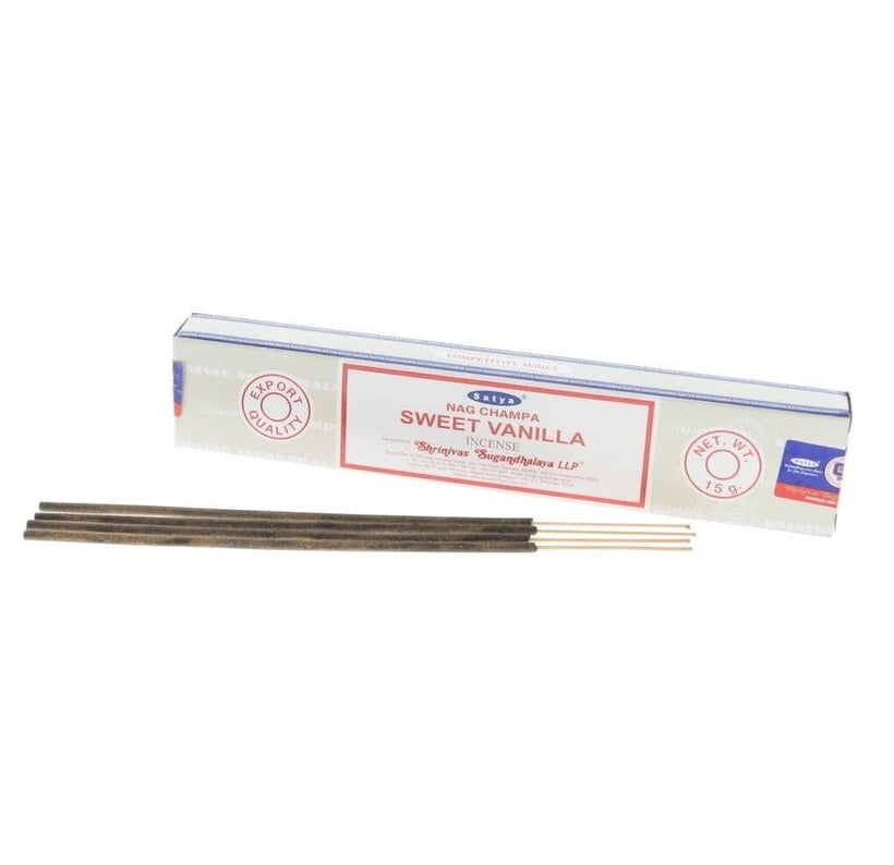 A box of Satya  incense sticks in Sweet Vanilla flavor, shown with several incense sticks placed in front of the packaging on a plain white background.